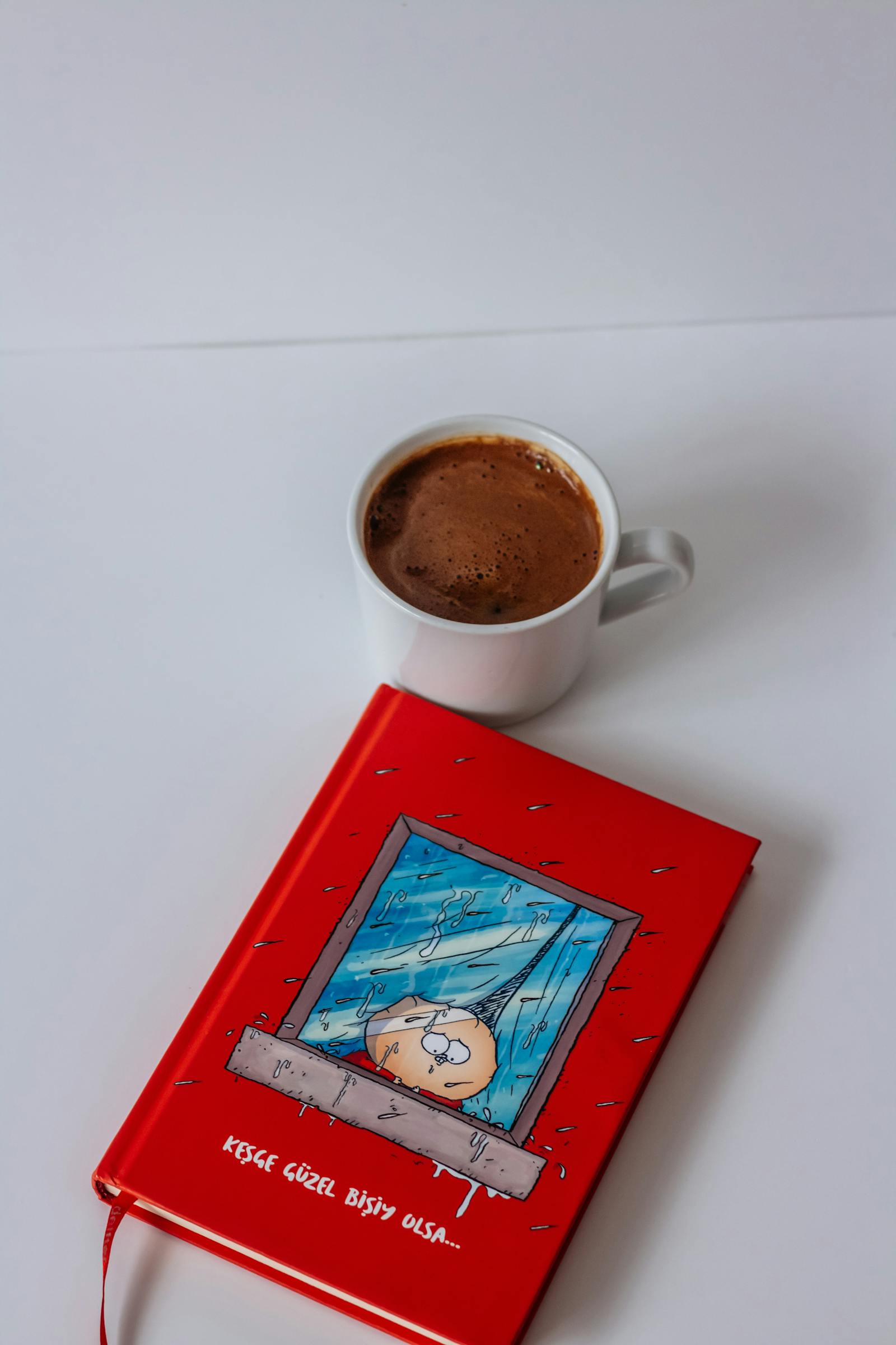 A morning ritual still life: an open notebook, a steaming mug of herbal tea, soft window light.